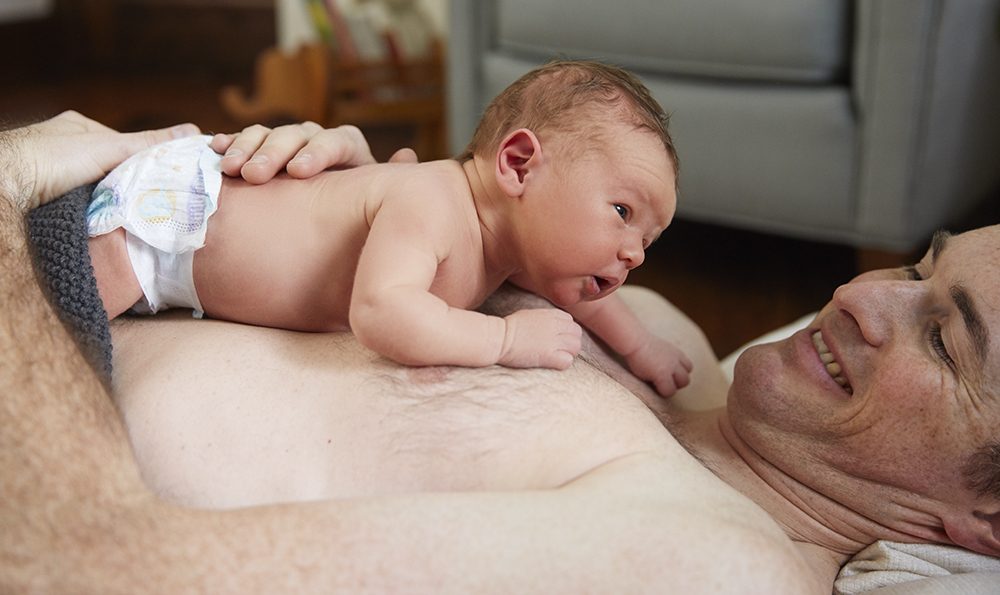 Father and baby enjoy skin-to-skin time.