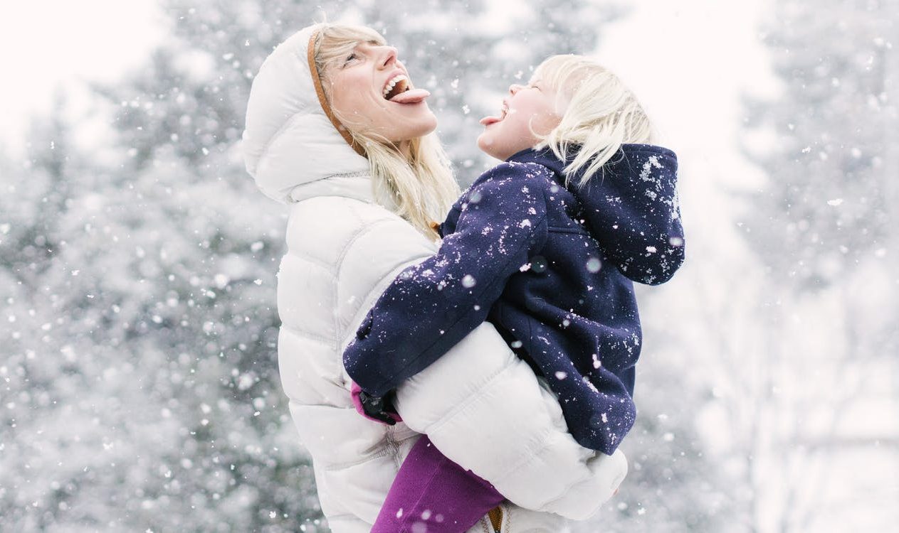Jessica Rolph, Co-founder and CEO of Lovevery, holding her daughter outside in the snow