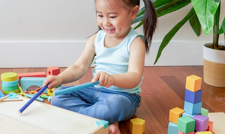 Toddler playing with the Block Set by Lovevery