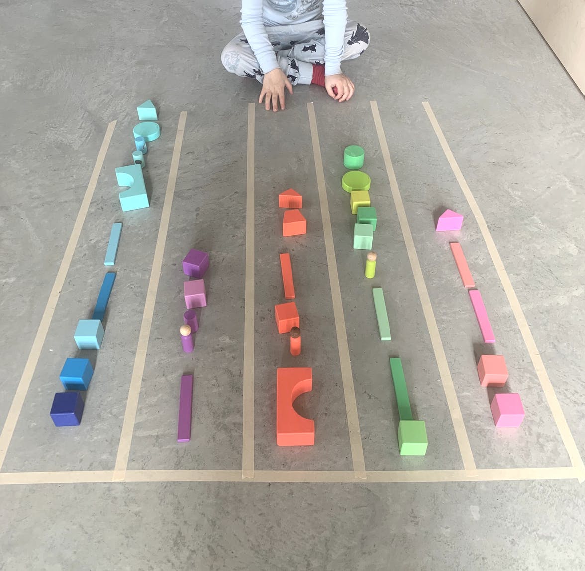 Stacking color coded blocks with the Block Set by Lovevery