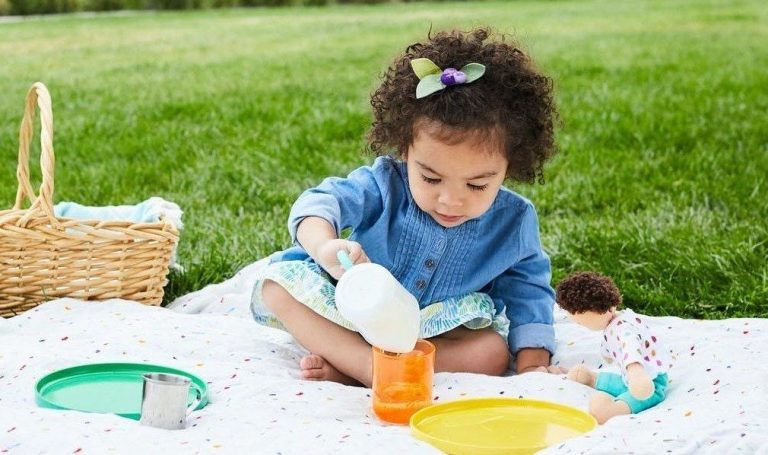 Toddler sitting outside having a picnic