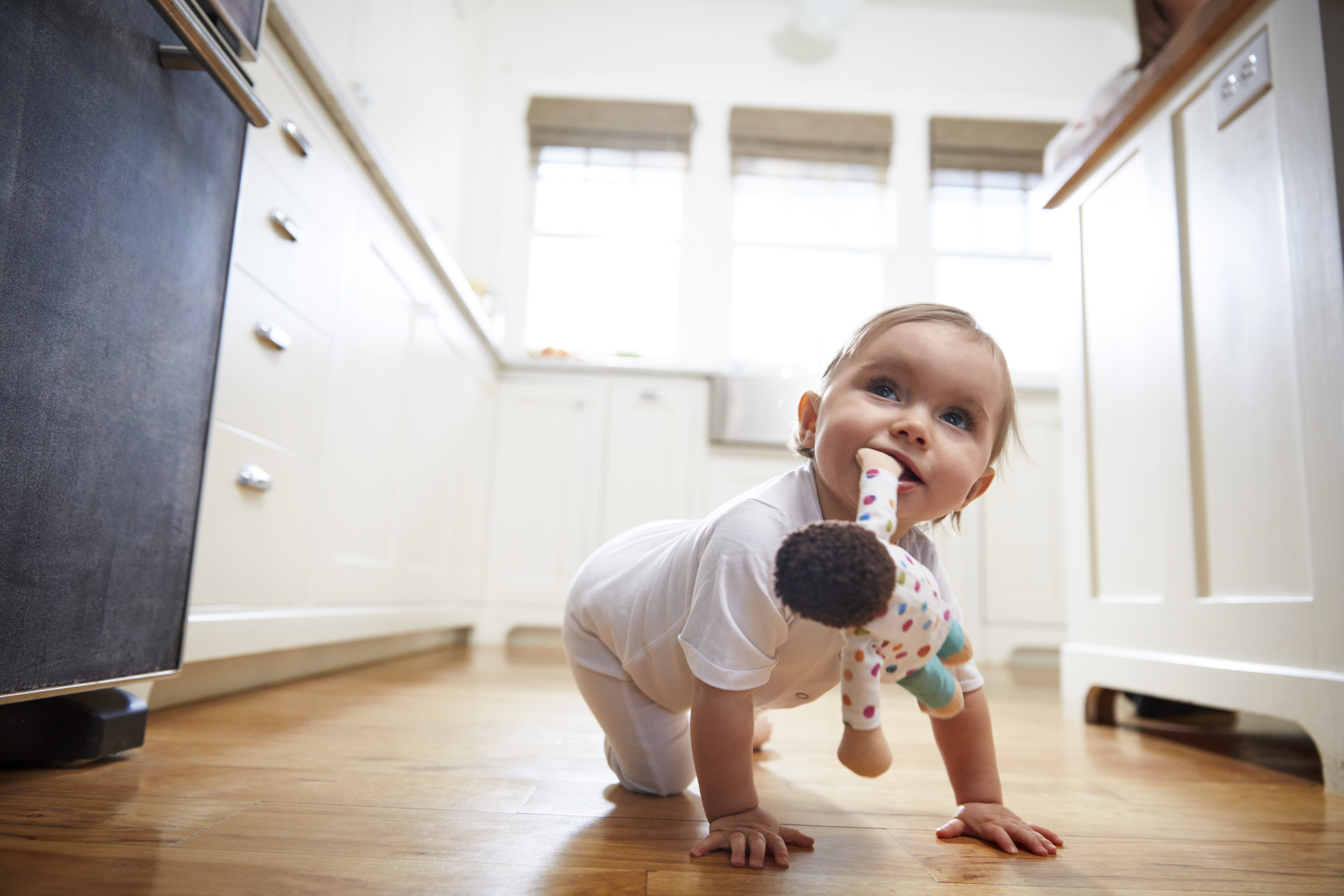 Toddler crawling with the Cotton Doll in their mouth