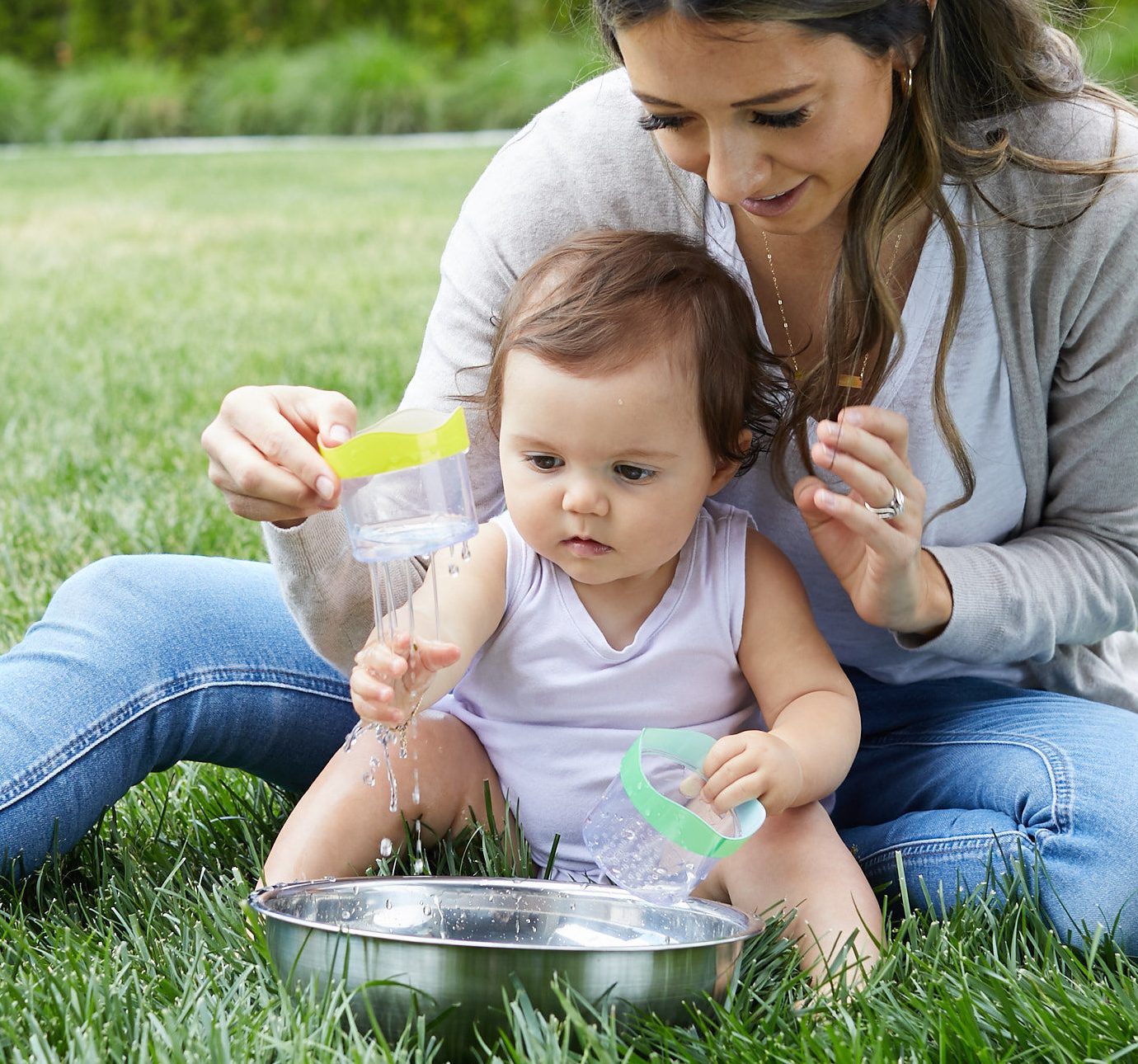 Woman and baby playing outside with the Lovevery Drip Drop cups