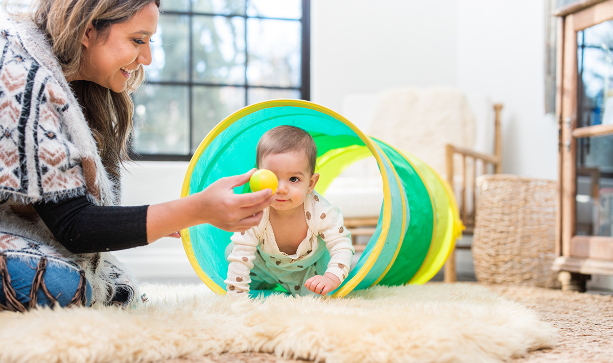Baby crawling through the Play Tunnel by Lovevery