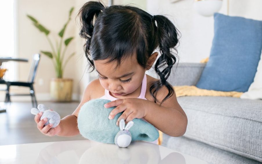 Toddler playing with a Lovevery toy