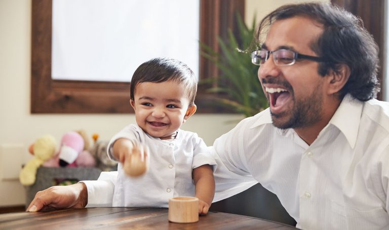 Father delights in his son's play.