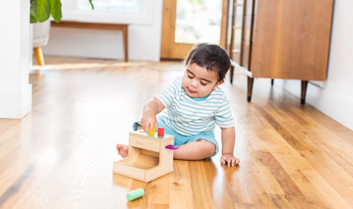 Toddler playing with the Wooden Peg Drop