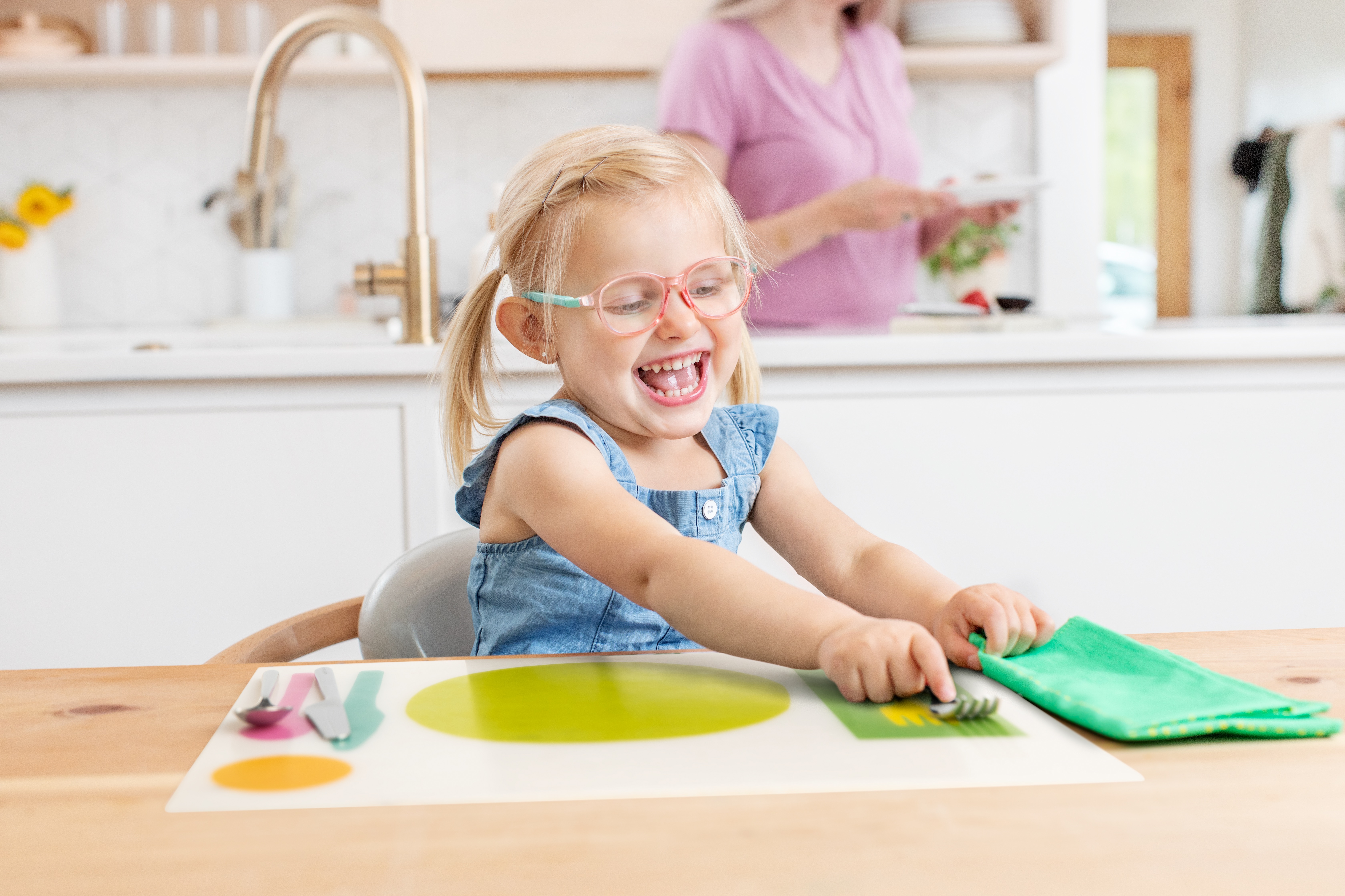 Toddler playing with the Montessori Placemat by Lovevery