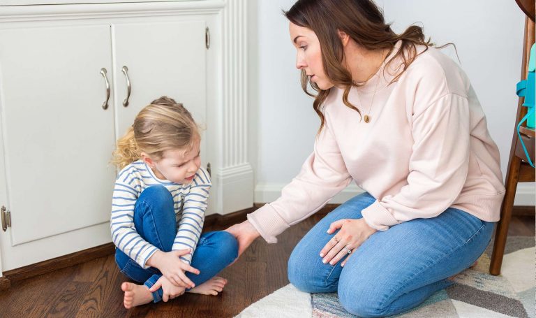 Mom consoles her daughter during a difficult moment.