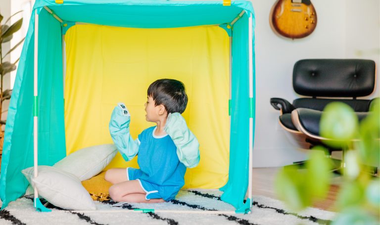 Child plays with puppets