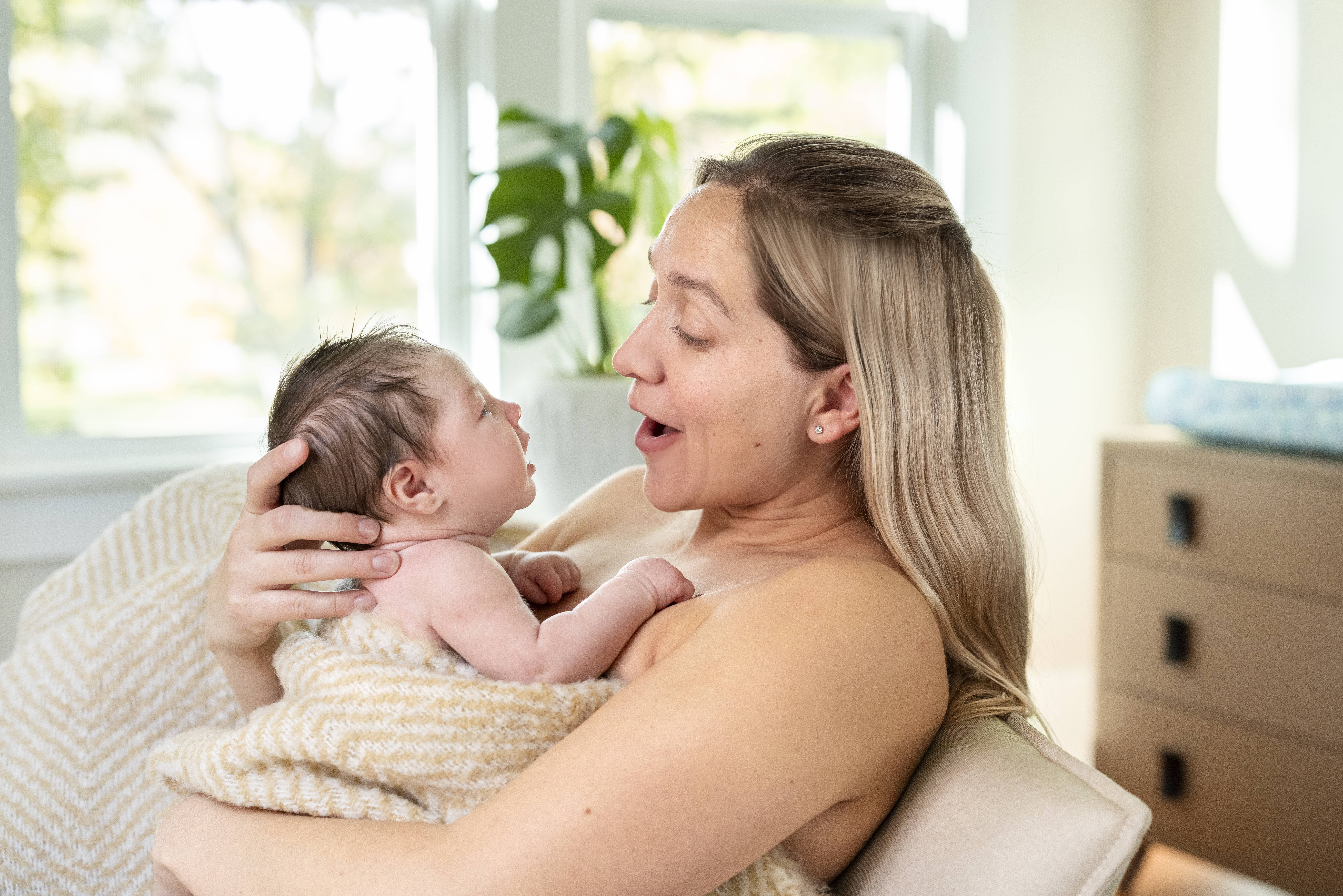Woman holding baby on her chest
