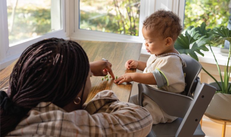 Mom feeds her baby at the table