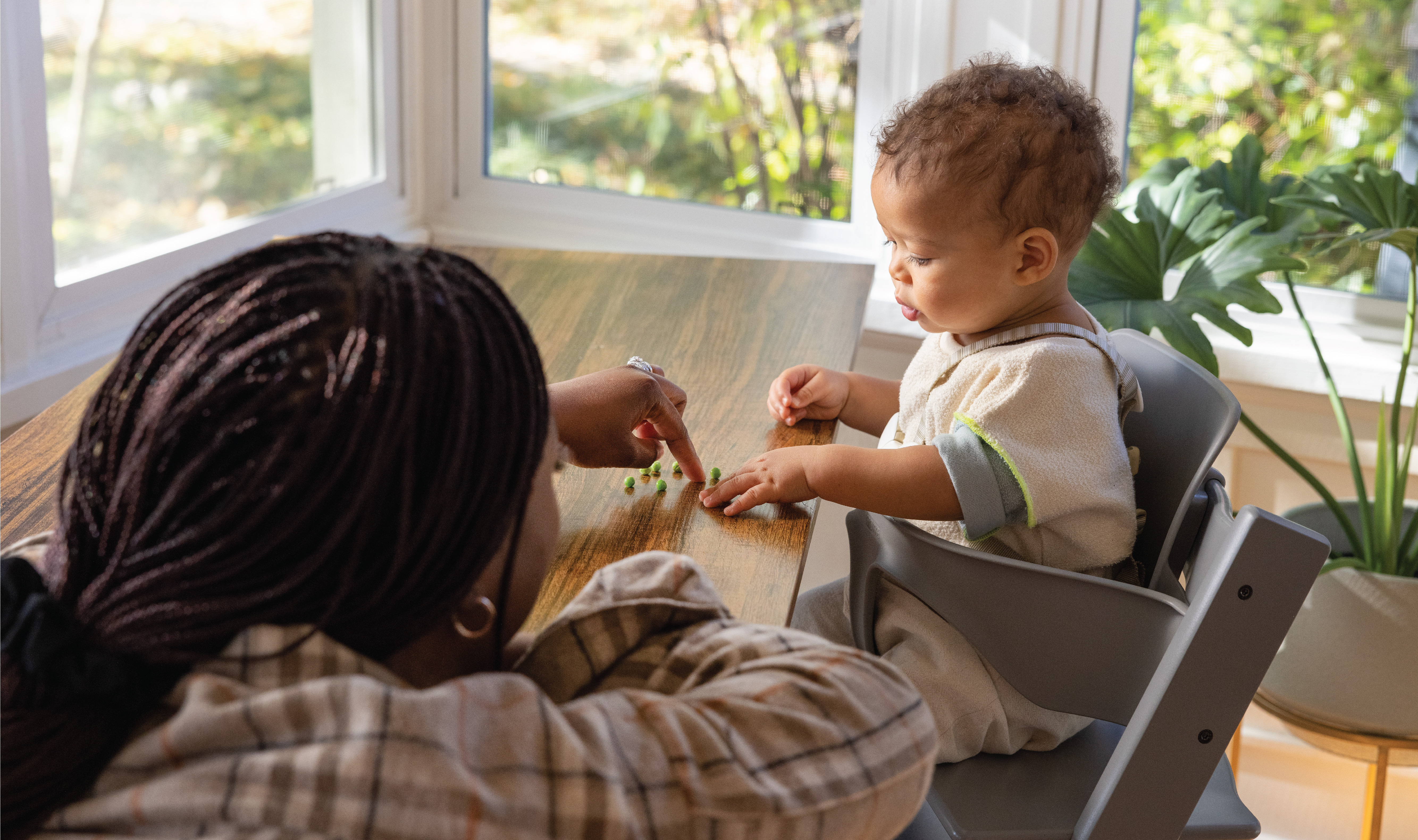 Mom feeds her baby at the table